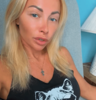 Ganna wearing a black tank top with a cat in sunglasses design.