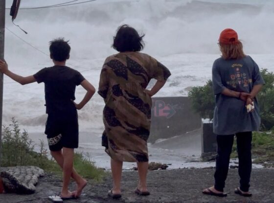 People watching huge waves crash as Super Typhoon Ragasa brings rain to Orchid Island, Taiwan.