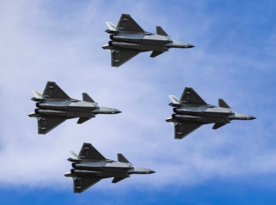 Four J-20 stealth fighter jets performing in the sky.