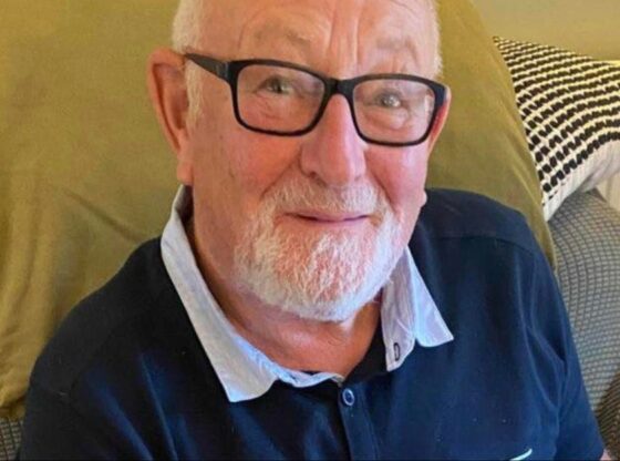 Clifford Wildgoose, a British grandfather, sitting with black-framed glasses, and a white beard.