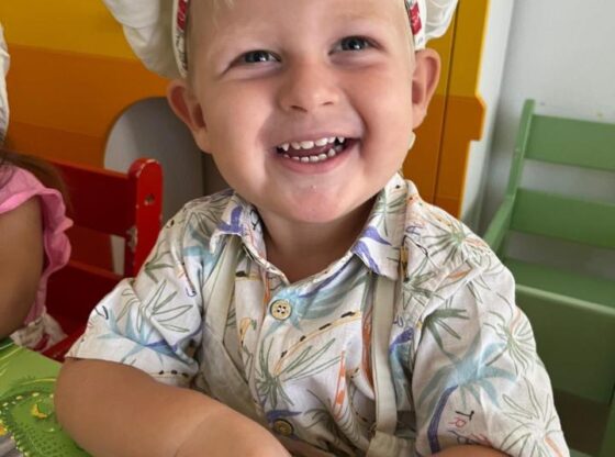 Missing British boy Oliver Pugh wearing a chef's hat and patterned shirt, smiling.