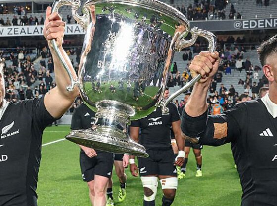New Zealand's Cortez Ratima (L) and Quinn Tupaea (R) hold up the Bledisloe Cup after their victory against Australia