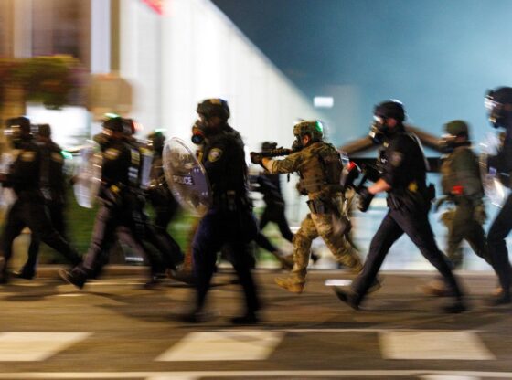 ICE agents charge towards protesters outside a detention facility in Portland, Oregon.