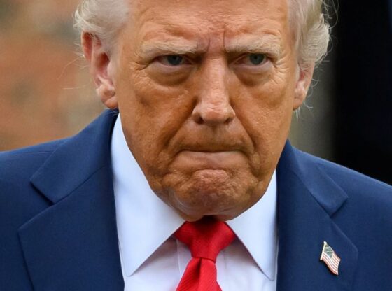 U.S. President Donald Trump in a blue suit and red tie.