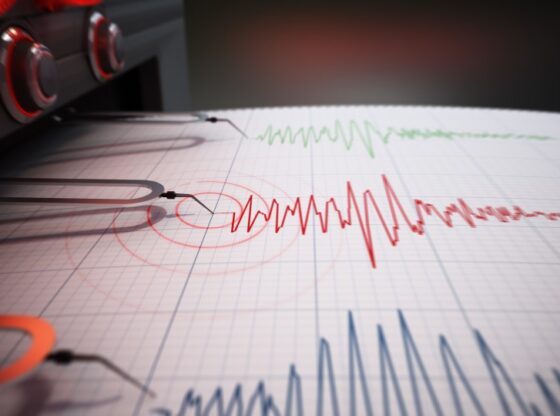 Illustration of a seismograph printing seismic activity records on a graph.