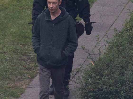 Christian Bruckner being led away by police.