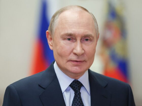 Russian President Vladimir Putin in a suit and tie, addressing contestants of the Intervision Song Contest via video link.