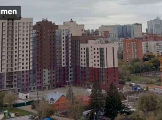 View of Tyumen, Russia, with residential buildings and construction sites.