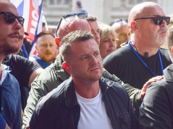 Tommy Robinson among a crowd at the "Unite The Kingdom" march in Westminster.