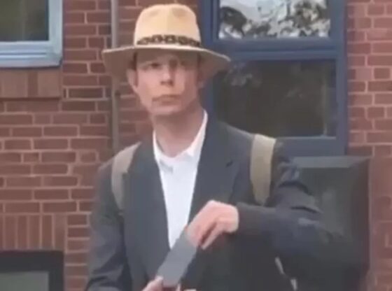 Christian Brueckner in a Panama hat and suit.