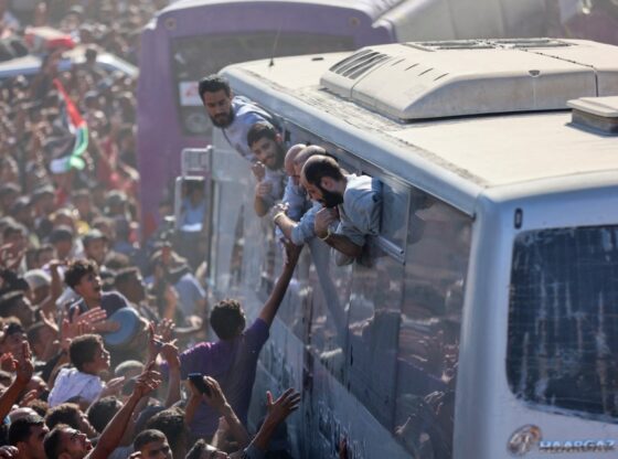Palestinians released from Israeli prisons reaching out from bus windows to supporters in Khan Yunis.