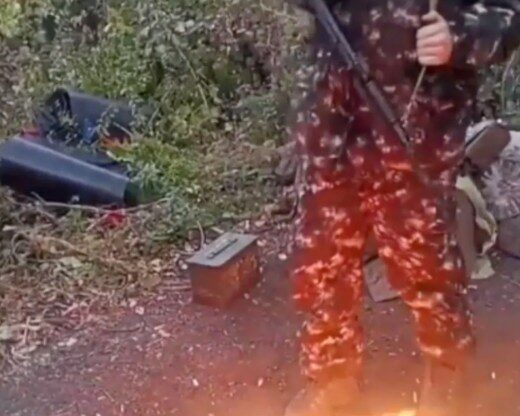 Aiden Minnis burning a UK passport on the ground.