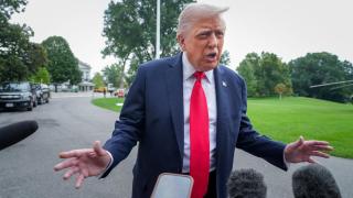 Donald Trump meets with journalists on the grounds of the White House.