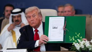Trump shows his signature on the Gaza peace agreement during the summit in Sharm el-Sheikh.
