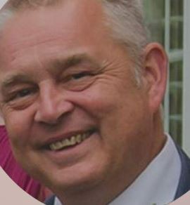 Headshot of a smiling man.