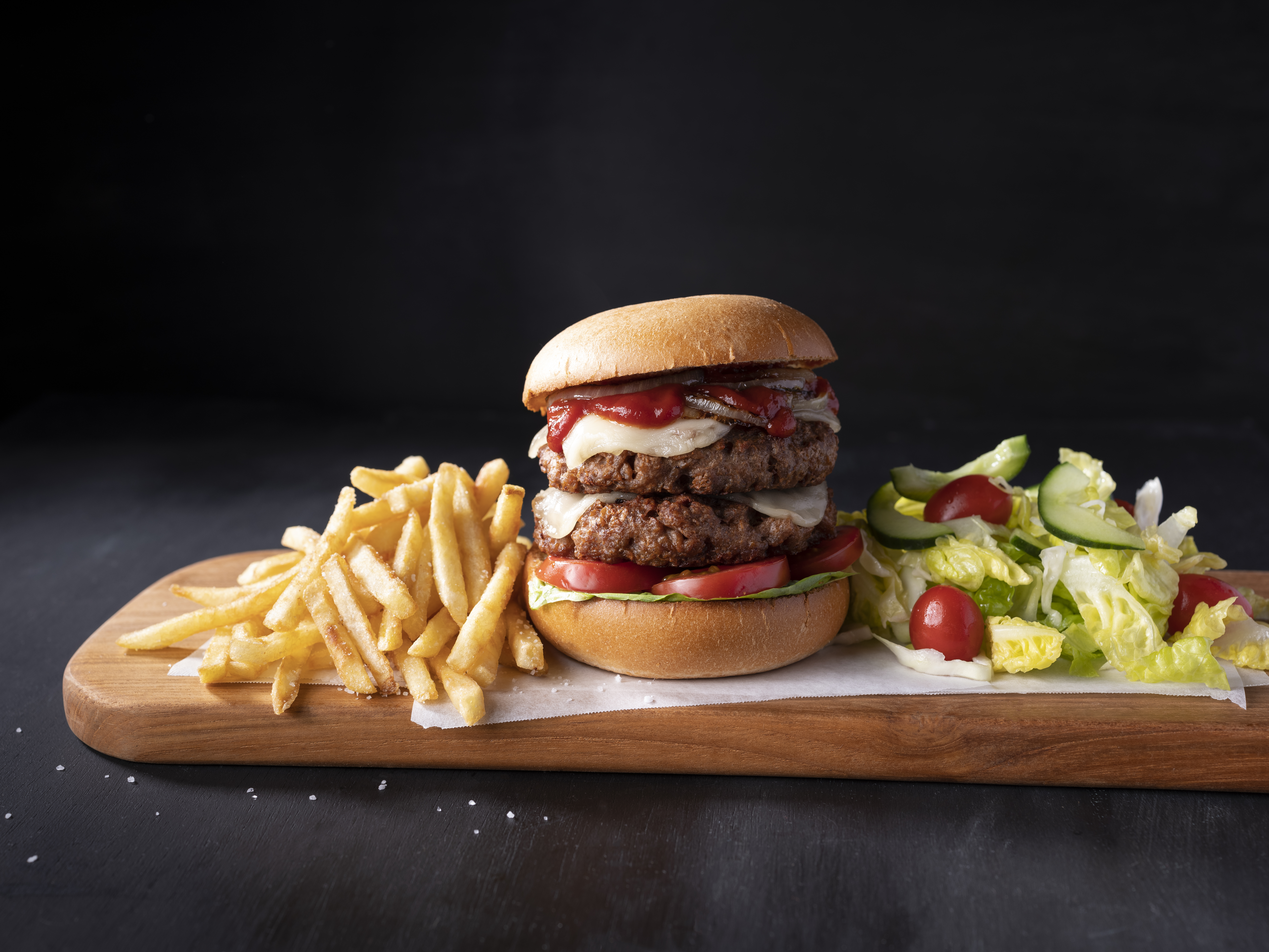 Vegan Double Cheeseburger on a wooden plank.
