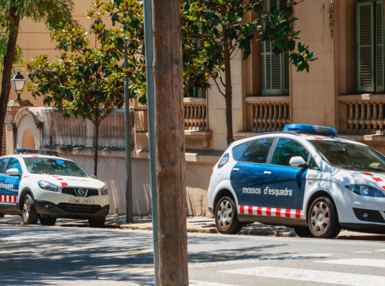 Police car parked in front of a small police station