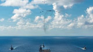 The aircraft carrier 'USS Gerald R. Ford' escorted by destroyers and fighters on its journey to the Caribbean.