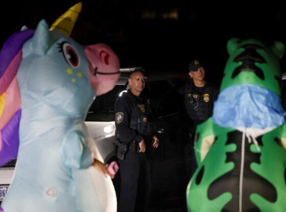 Protesters in inflatable costumes protest outside the Department of Homeland Security headquarters on Sunday in Charlotte.