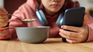 File image of a minor with a cell phone.