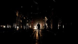 People walk on the street at night as Cuba is affected by an island-wide blackout, in Havana.