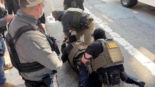 File image of federal agents detaining an immigrant allegedly without documentation.