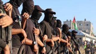 Palestinian militants stand guard on the day hostages held in Gaza are handed over to the International Committee of the Red Cross.