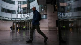 A person walks in front of the BBC headquarters in London.