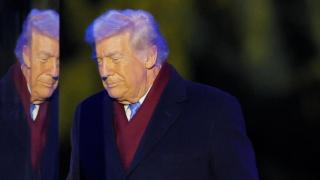 Donald Trump and his reflection during the National Christmas Tree ceremony at the White House in Washington.